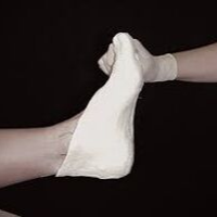 Clinician mobilizing patient’s foot during treatment