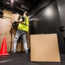 Worker performing interior maintenance in safety gear