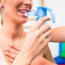 Patient using inhaler for respiratory treatment”
