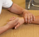 Clinician assessing and mobilizing patient’s wrist